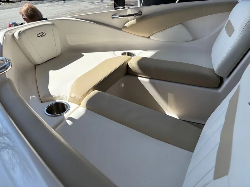 Slide: The Image of 2017 Regal 1900 ES boat interior with beige seating and cup holders. - 9