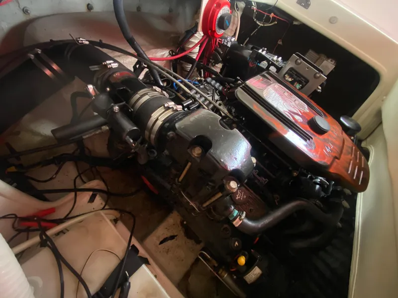Slide: The Image of 2005 Rinker 232 Captiva Cuddy engine compartment with visible components and wiring. - 20