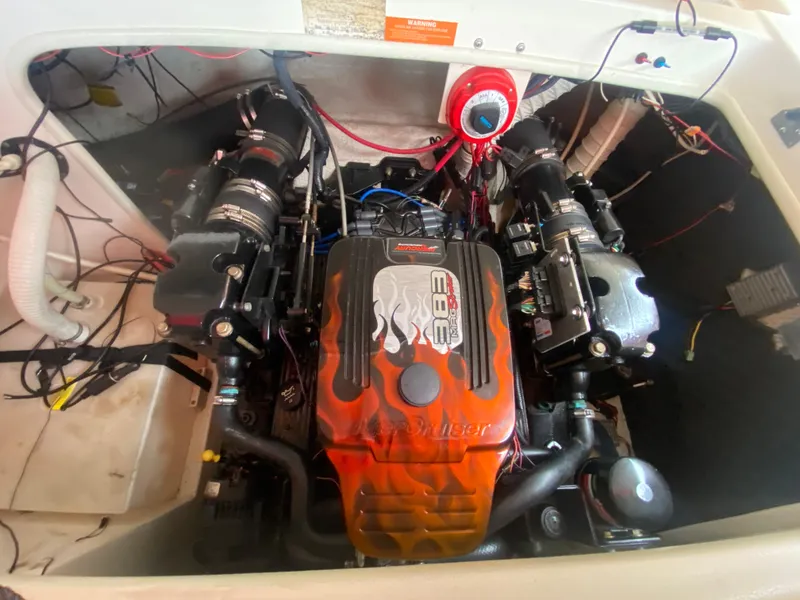 Slide: The Image of 2005 Rinker 232 Captiva Cuddy engine compartment with a custom-painted engine. - 19