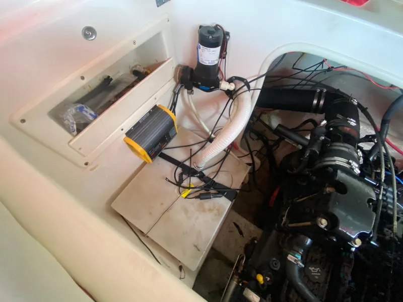 Slide: The Image of 2005 Rinker 232 Captiva Cuddy engine compartment with various components and wiring. - 21