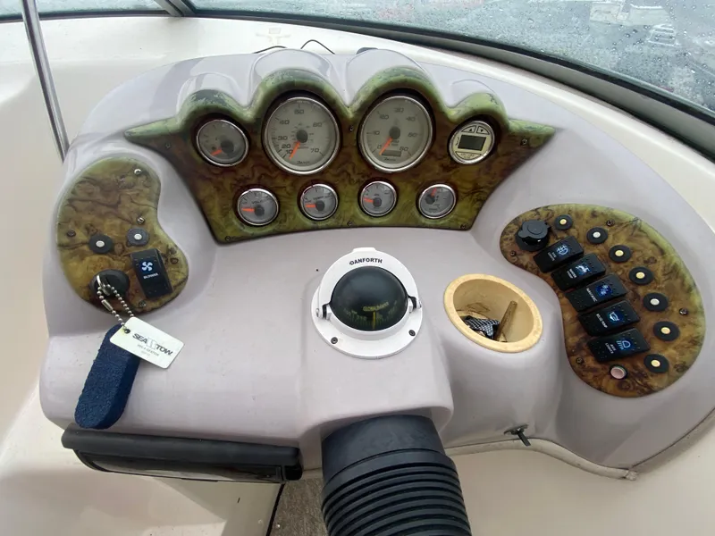 Slide: The Image of 2005 Rinker 232 Captiva Cuddy dashboard with gauges and controls. - 18