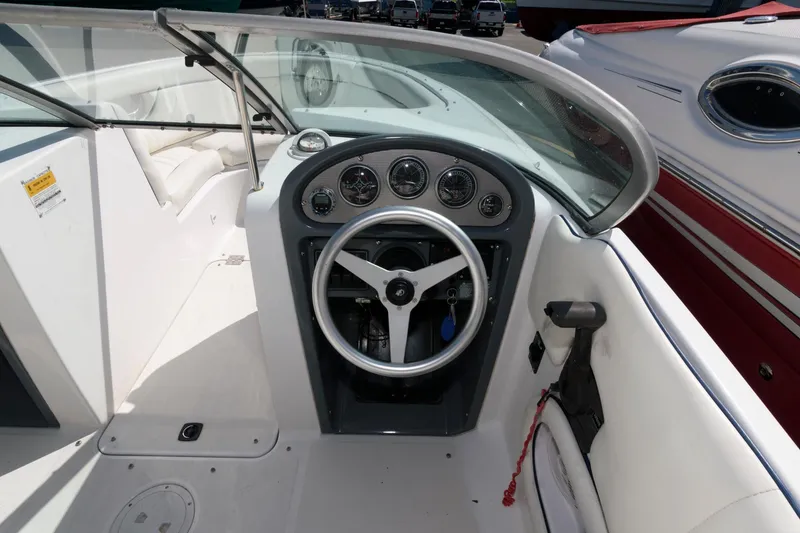 Slide: The Image of 2001 Chris-Craft Launch 22 boat dashboard with steering wheel and gauges. - 10