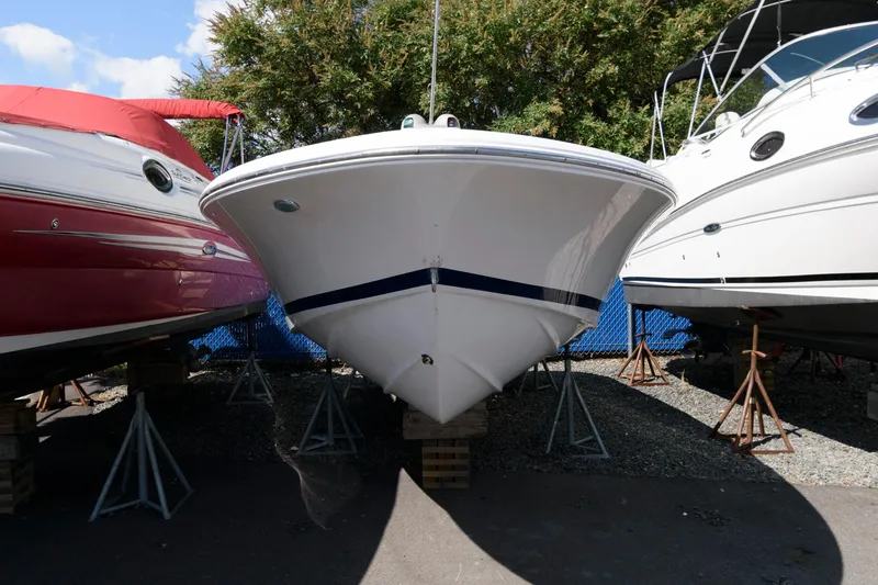 Slide: The Image of 2001 Chris-Craft Launch 22 boat on stands, flanked by other boats. - 2