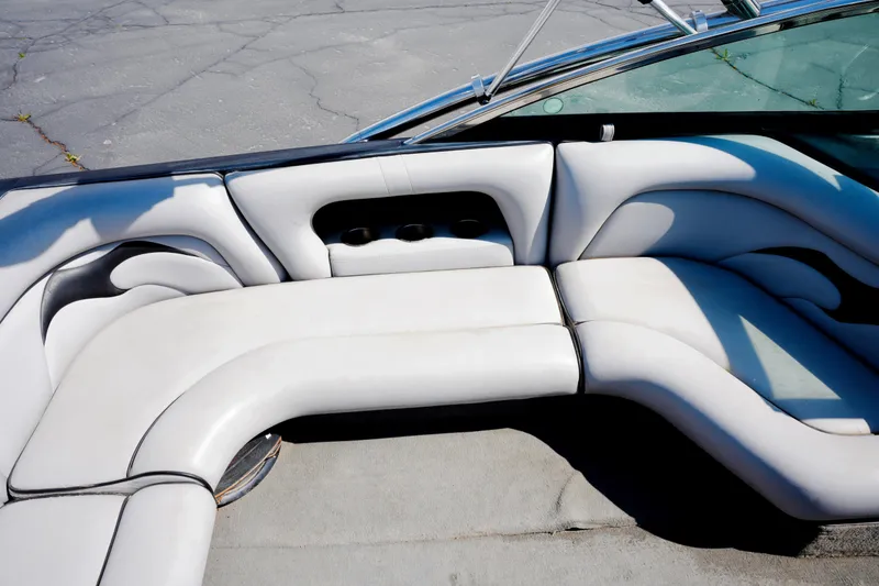 Slide: The Image of 2007 Calabria PVO-V2 boat interior with white cushioned seating and cup holders. - 12