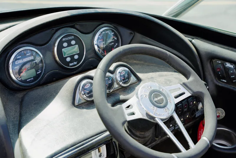 Slide: The Image of Dashboard of a 2007 Calabria PVO-V2 boat with steering wheel and gauges. - 13