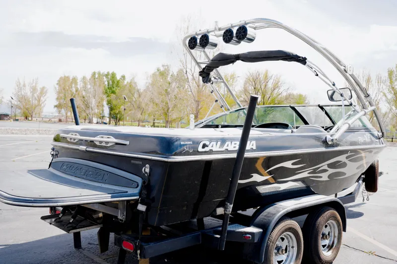 Slide: The Image of 2007 Calabria PVO-V2 boat on trailer, featuring sleek design and custom graphics. - 3