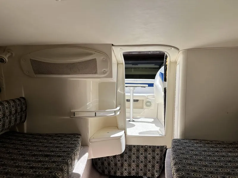 Slide: The Image of Interior cabin of a 2001 Rinker Captiva 232 boat with patterned seating. - 10
