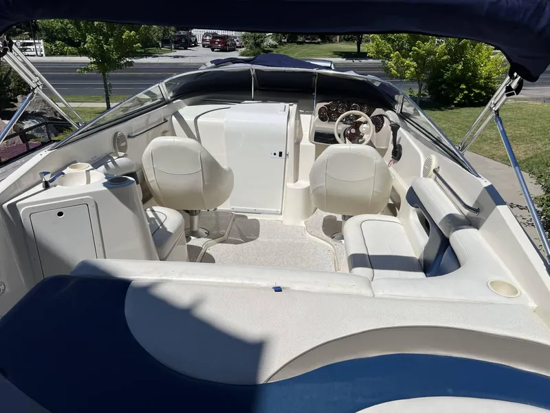 Slide: The Image of 2001 Rinker Captiva 232 boat interior with white seating and steering console. - 5