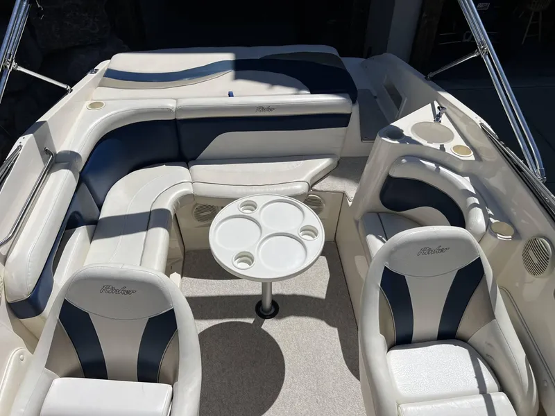 Slide: The Image of Interior of a 2001 Rinker Captiva 232 boat with white and navy seating. - 6