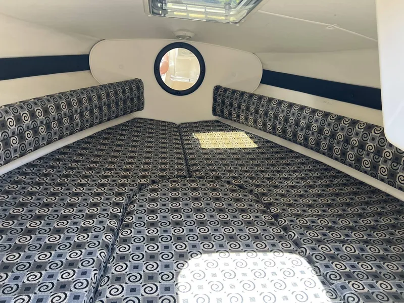 Slide: The Image of Interior cabin of a 2001 Rinker Captiva 232 boat with patterned cushions. - 8