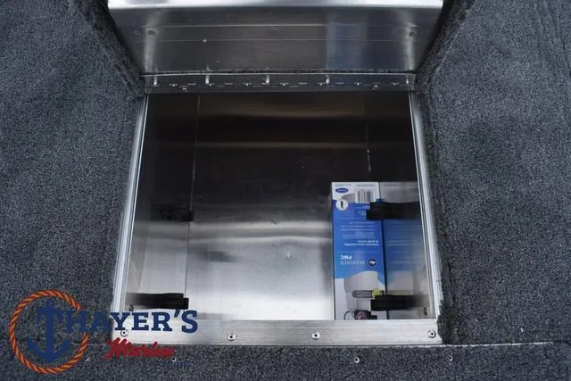 Slide: The Image of Open storage compartment in 2024 Tracker Pro 170 boat with Thayer's Marine logo. - 14