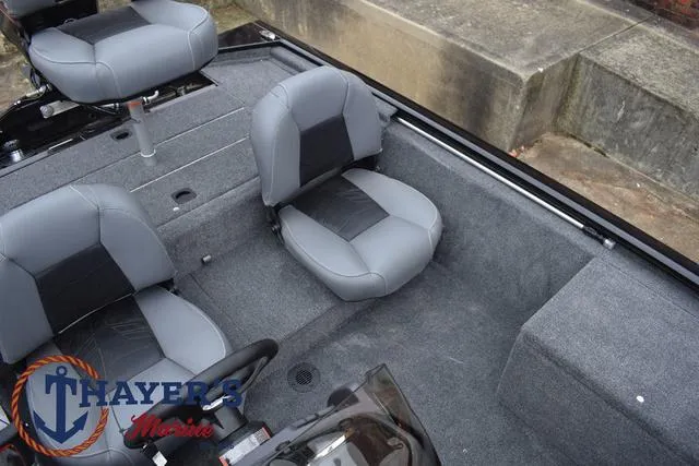 Slide: The Image of 2024 Tracker Pro 170 boat interior with gray seating and Thayer's Marine logo. - 20