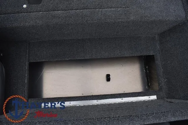 Slide: The Image of 2024 Tracker Pro 170 storage compartment with carpeted interior. - 22