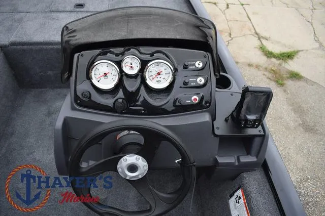 Slide: The Image of 2024 Tracker Pro 170 boat dashboard with steering wheel and gauges. - 26