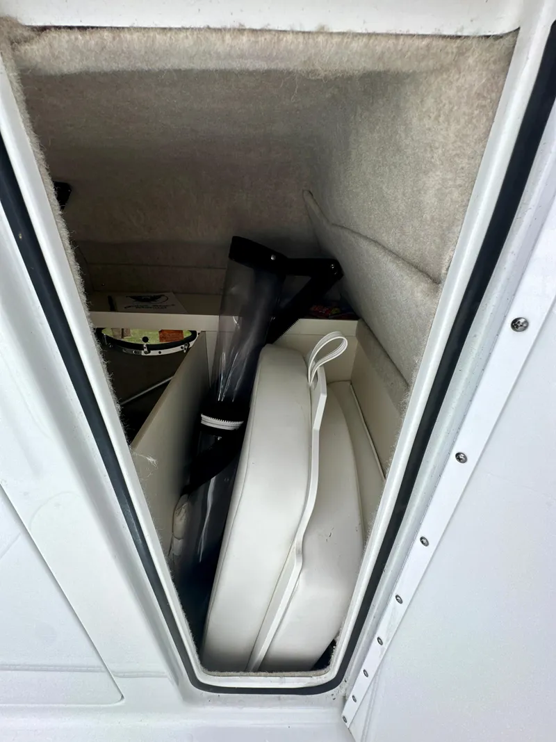Slide: The Image of Storage compartment of a 2008 Formula 310 Bowrider boat, showing interior items. - 15