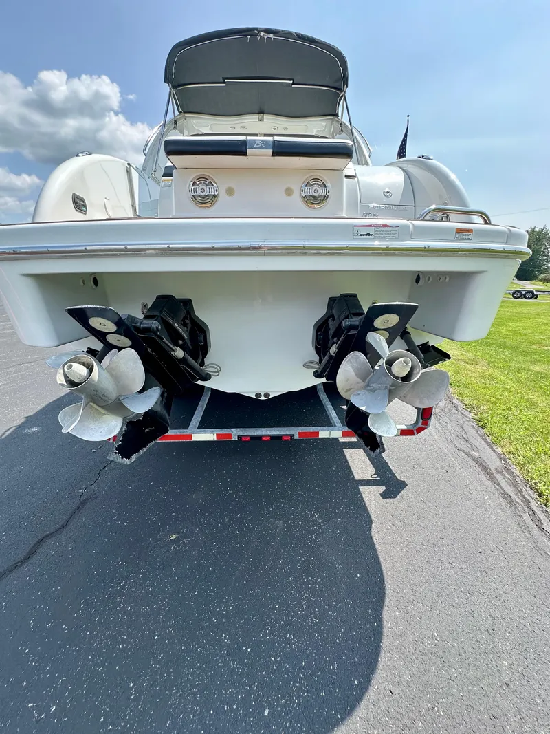 Slide: The Image of 2008 Formula 310 Bowrider boat rear view with dual propellers on a trailer. - 25