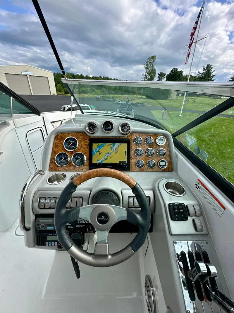 Slide: The Image of 2008 Formula 310 Bowrider dashboard with steering wheel, gauges, and navigation screen. - 6