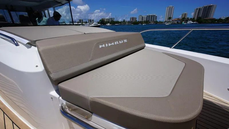 Slide: The Image of 2024 Nimbus Commuter 11 #082 boat with cushioned seating on deck. - 13