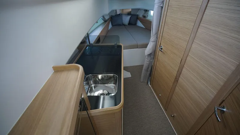 Slide: The Image of 2024 Nimbus Commuter 11 #082 interior with kitchenette and sleeping area. - 17