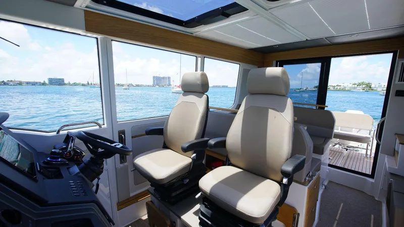 Slide: The Image of Interior of 2024 Nimbus Commuter 11 #082 boat with dual captain chairs. - 18