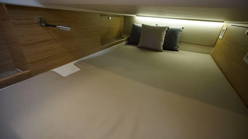 Slide: The Image of 2024 Nimbus Commuter 11 #082 cozy cabin bed with pillows and wooden accents. - 20