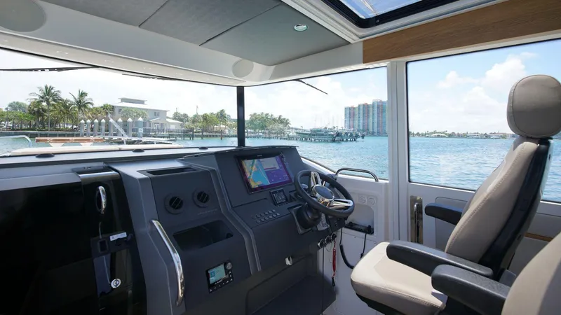 Slide: The Image of Interior of 2024 Nimbus Commuter 11 #082 boat with modern dashboard and waterfront view. - 8