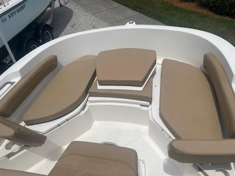 Slide: The Image of 2022 Bayliner Trophy T20CC boat with beige cushioned seating. - 6