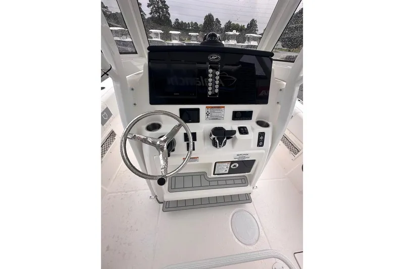Slide: The Image of 2025 Sea Fox 268 Commander helm station with steering wheel and control panel. - 14