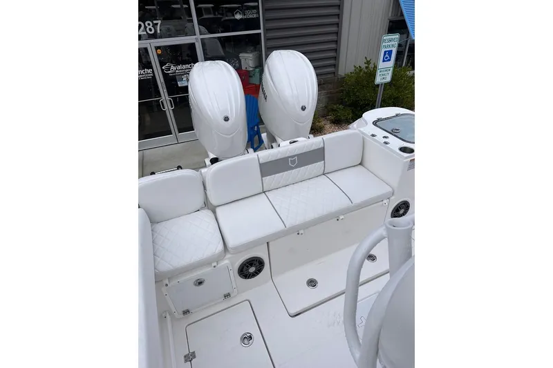 Slide: The Image of 2025 Sea Fox 268 Commander boat with twin outboard engines and cushioned seating. - 7