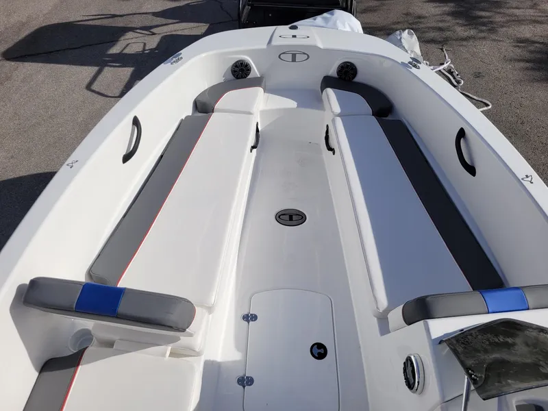 Slide: The Image of 2024 Tahoe T18 boat interior with cushioned seating and storage compartments. - 10