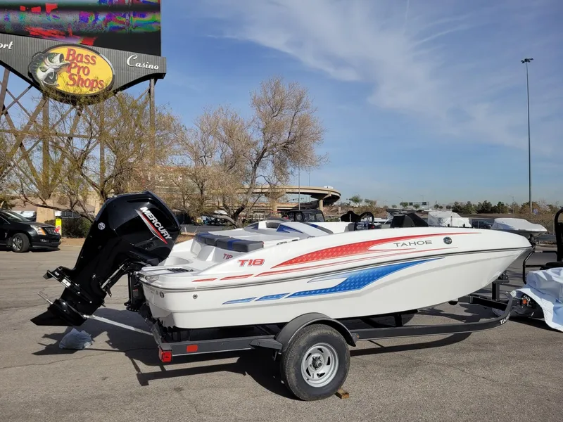 Slide: The Image of 2024 Tahoe T18 boat with trailer at Bass Pro Shops parking lot. - 2