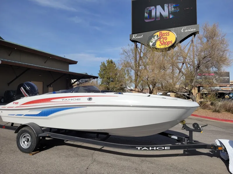 Slide: The Image of 2024 Tahoe T18 boat on trailer near Bass Pro Shops sign. - 3