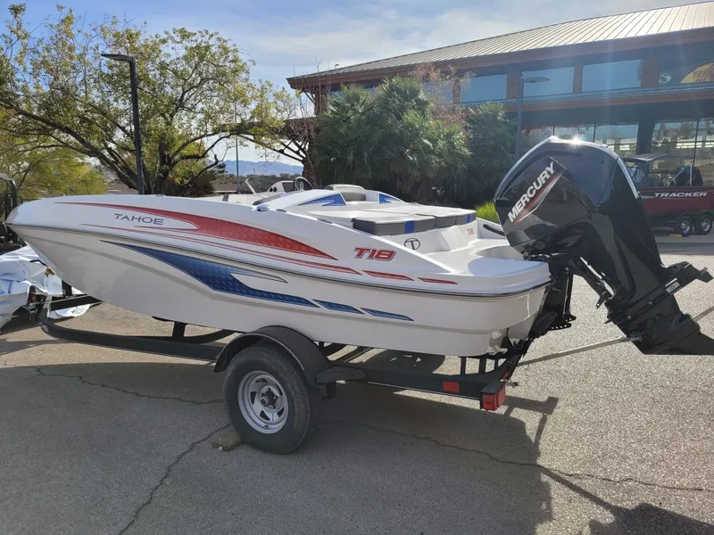 Slide: The Image of 2024 Tahoe T18 boat with Mercury engine on trailer, parked outdoors. - 4