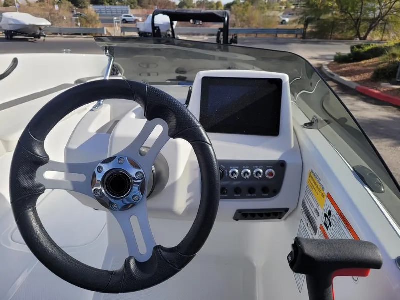 Slide: The Image of 2024 Tahoe T18 boat dashboard with steering wheel and control panel. - 6