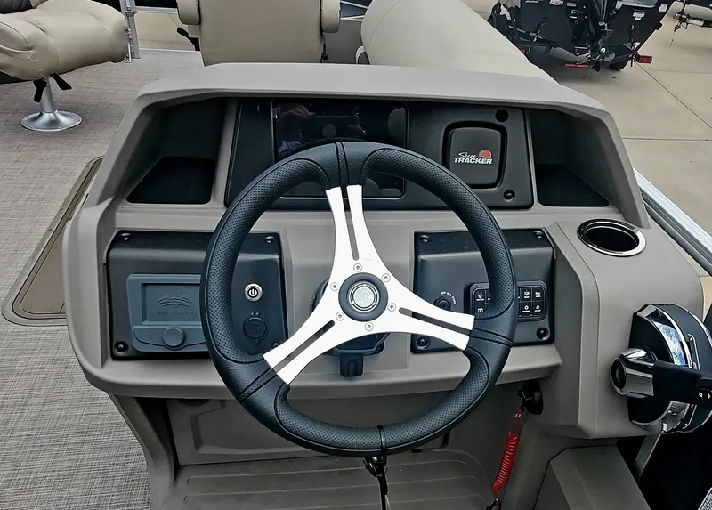 Slide: The Image of 2024 Sun Tracker Sportfish 24 XP3 steering console with modern controls and comfortable seating. - 3