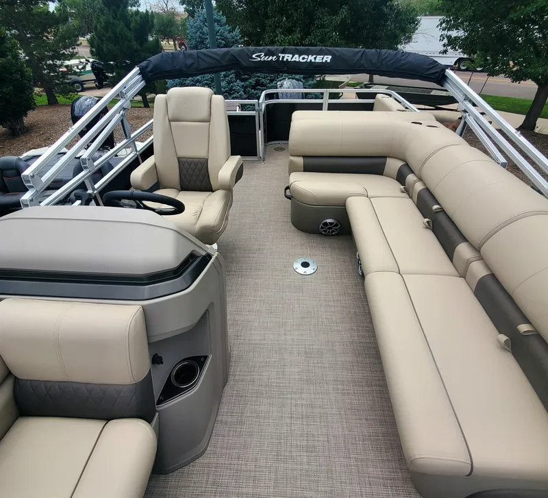 Slide: The Image of 2024 Sun Tracker Sportfish 24 XP3 pontoon boat with spacious seating and modern design. - 4