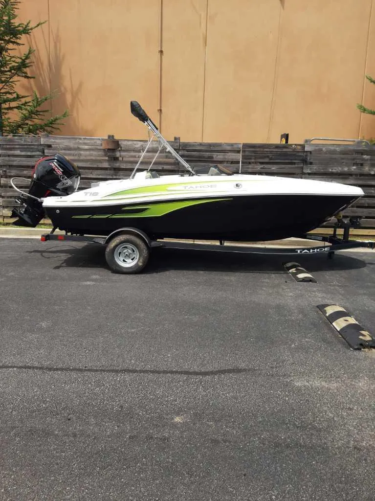 Slide: The Image of 2024 Tahoe T18 boat on trailer, parked outdoors. - 0