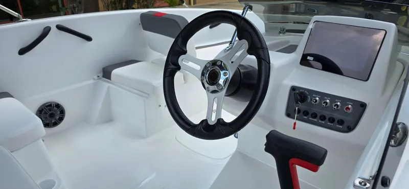 Slide: The Image of 2024 Tahoe T16 boat interior with steering wheel and control panel. - 4