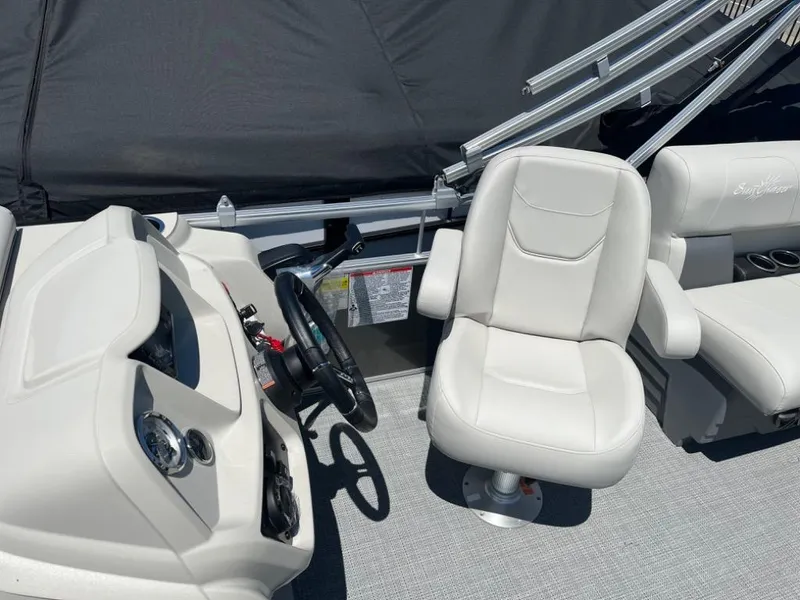 Slide: The Image of 2024 SunChaser Vista 20 LR boat interior with captain's chair and steering console. - 7