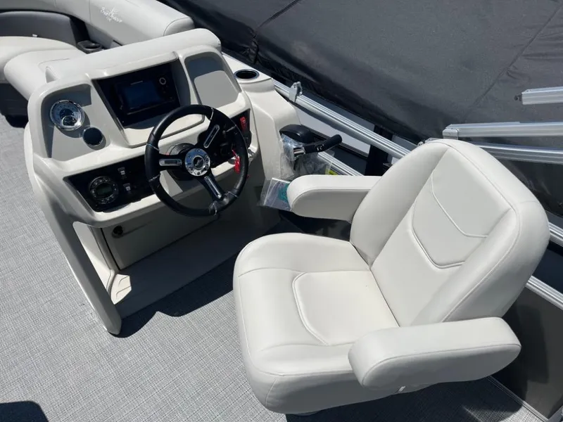 Slide: The Image of 2024 SunChaser Vista 20 LR boat cockpit with steering wheel and captain's chair. - 8