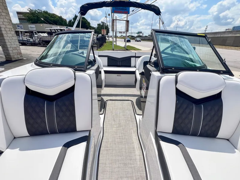 Slide: The Image of 2024 Monterey 218 SS boat interior with sleek white and black seating. - 14