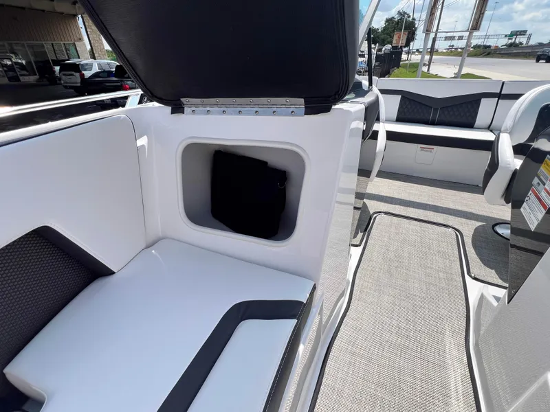 Slide: The Image of 2024 Monterey 218 SS boat interior with open storage compartment and seating. - 15