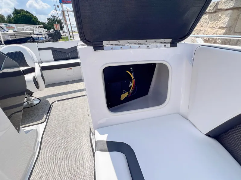 Slide: The Image of 2024 Monterey 218 SS boat interior with open storage compartment. - 16