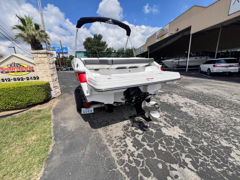Slide: The Image of 2024 Monterey 218 SS boat displayed outdoors at dealership. - 20