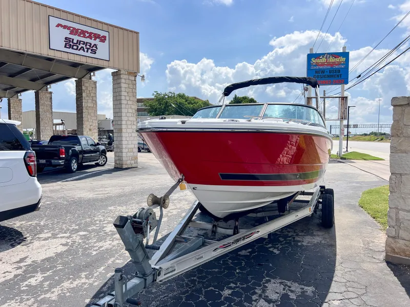 Slide: The Image of 2024 Monterey 218 SS boat on trailer at dealership, sunny day. - 3