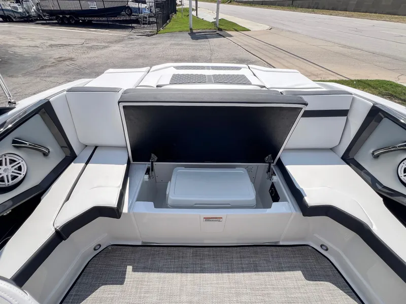 Slide: The Image of 2024 Monterey 218 SS boat interior with open storage compartment and seating. - 8
