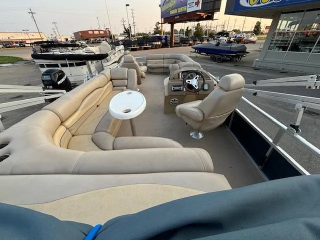 Slide: The Image of 2009 Bennington 2575RLi pontoon boat with beige seating and helm station. - 11