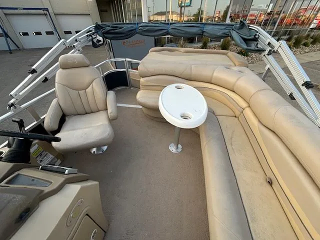 Slide: The Image of 2009 Bennington 2575RLi pontoon boat interior with beige seating and captain's chair. - 16
