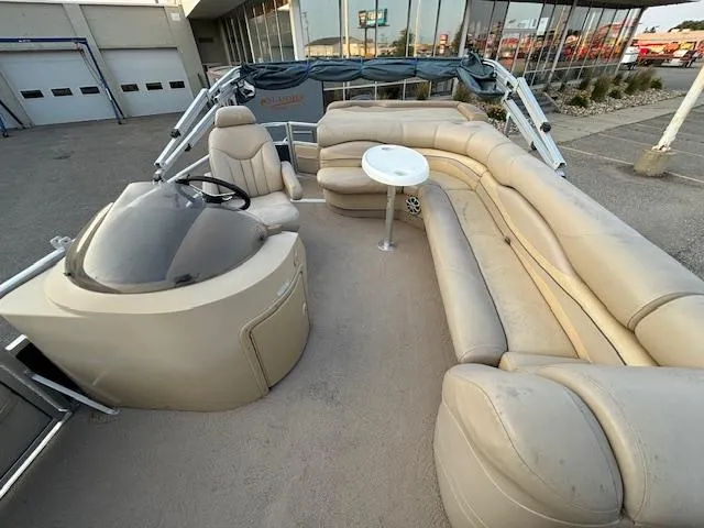 Slide: The Image of 2009 Bennington 2575RLi pontoon boat with beige seating and helm station. - 17