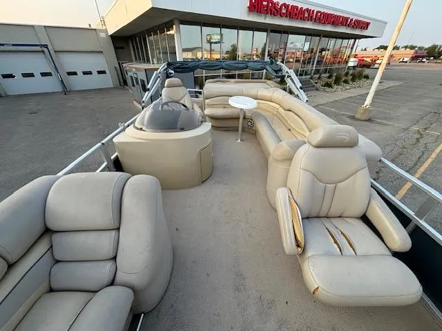Slide: The Image of 2009 Bennington 2575RLi pontoon boat with beige seating and table. - 18